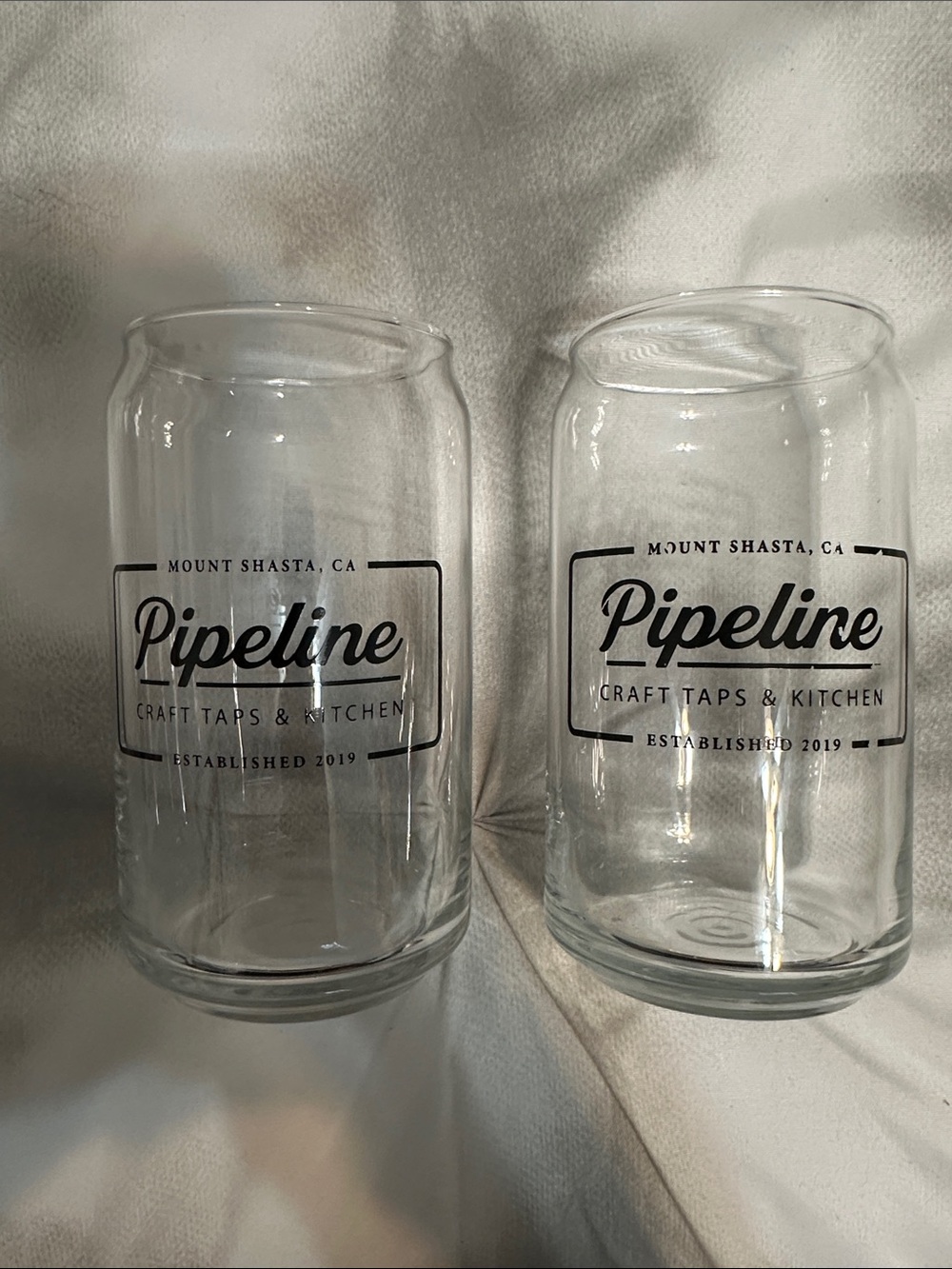 Myt. Shasta Pipeline craft taps and kitchen. Clear glass with black writing.